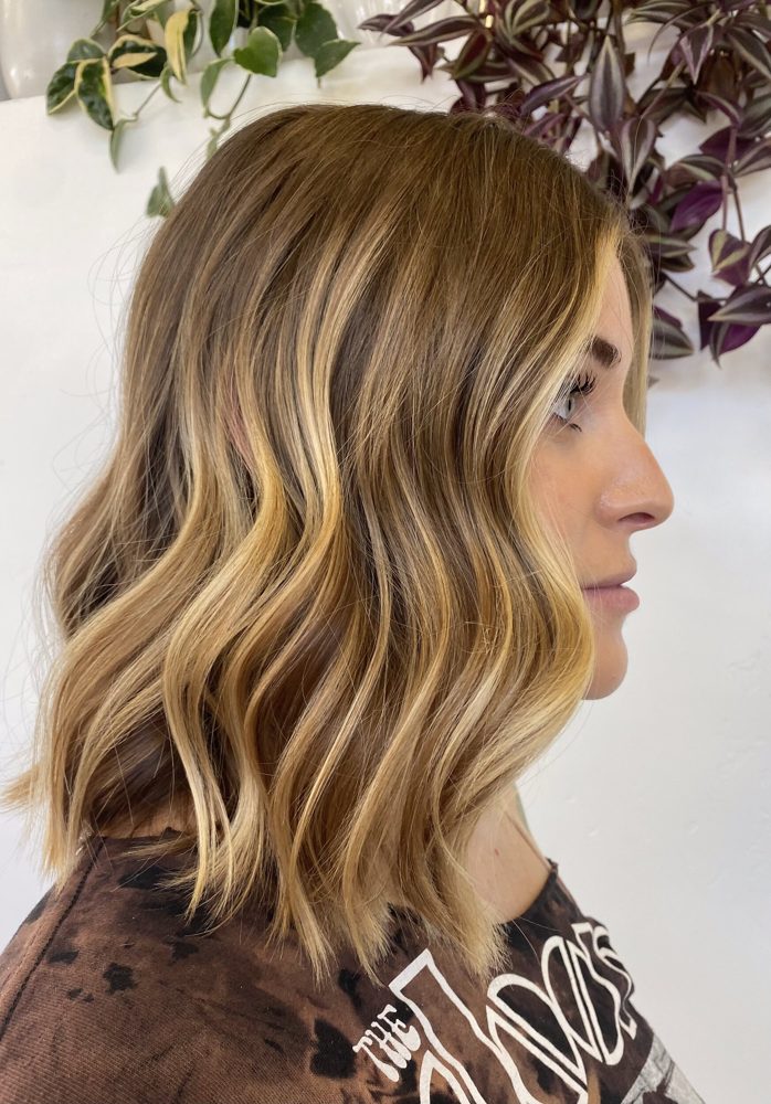 Wavy hair with dimensional, grown-out highlights